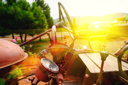 Closeup view of the old machine of tractor. Soft focus and lighting flare effect