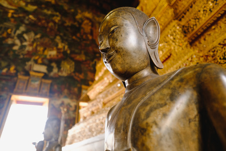 close up face on buddha head statue with lighting effect.  Selective focus face buddha statue.の写真素材