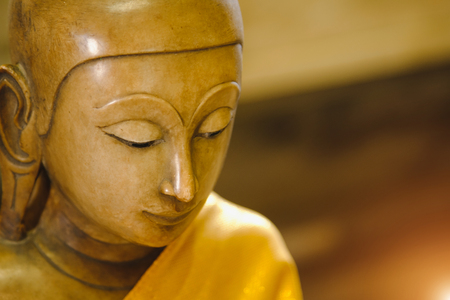 close up face on buddha head statue with lighting effect.  Selective focus face buddha statue.の写真素材