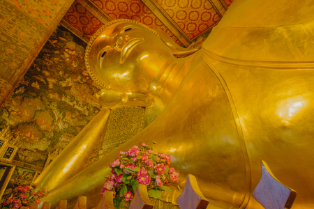 Reclining golden Buddha statue with thai art architecture in church Wat Pho (Temple of the Reclining Buddha) in Bangkok,Thailand.のeditorial素材
