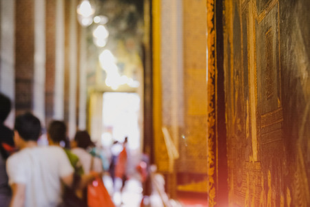 Thai art architecture Wall in church Wat Pho (Temple of the Reclining Buddha) with blurred tourist background in Bangkok,Thailand.の写真素材