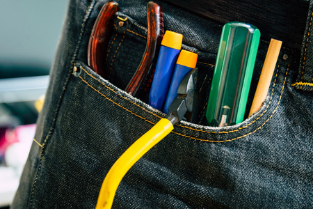 Set of engineer hand tools in jeans, A jeans with engineer constructor tools. Several engineer constructor tools on a denim workers.の写真素材