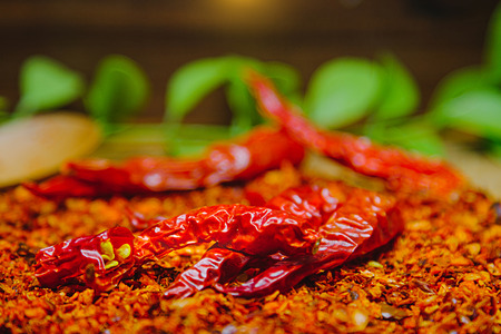 Red hot chili peppers on chilli dried chopped with rustic wood background. Concept of hot food and Vegetable.の写真素材