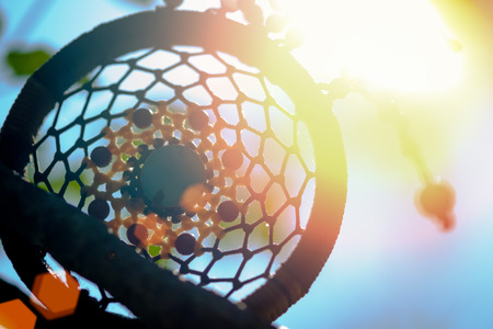 soft lighting sunshine in Dreamcatcher on the tree with green natural blurred bokeh background.の写真素材