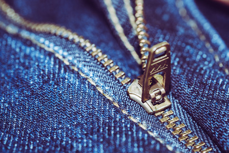 Blue Jean with gold zipper. selected focus. background and textures.の写真素材