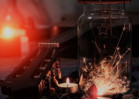Vintage photo of  Concept of sparklers in Glass jar with some of the guitar on blurred light candle...