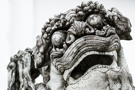Black and white image of Chinese Stone Lion stand guard at a gate of Wat Pho (Pho Temple) in Bangkok, Thailandの写真素材