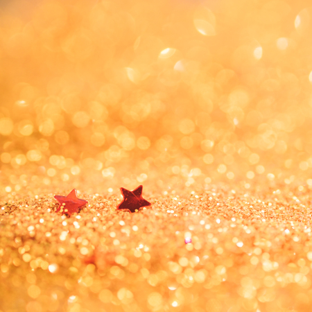 Soft focus and selective image on Red star on Gold light bokeh texture abstract background. Christmas abstract template.の写真素材