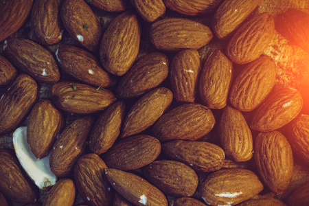 group of almonds on wooden background.の写真素材