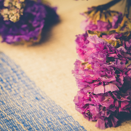 Bouquet of dried wild purple flowers on table background with vintage image style and soft light.の写真素材