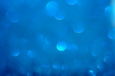 Blue bokeh light is the soft blurred circles of light white and light blue . Winter Christmas...