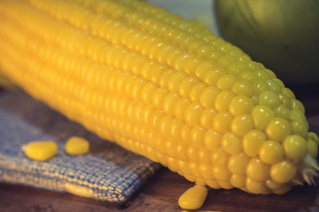 Vintage image of Golden sweet corn boil vegetable on wood.の写真素材