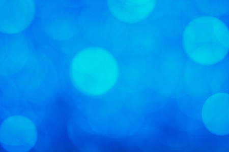 Blue bokeh light is the soft blurred circles of light white and light blue . Winter Christmas background texture Wallpaper concept.の写真素材
