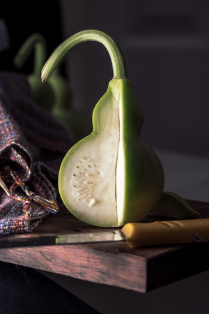 Vintage image and soft light of slice fresh bottle gourd or calabash  for cooking on wood.の写真素材