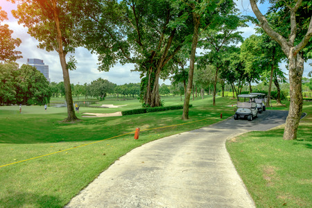 Golf car in green grass background in golf course ,Bangkok Thailand.の写真素材
