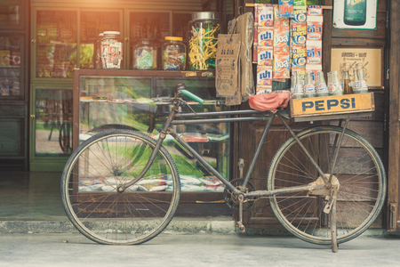 BANGKOK, THAILAND - July 1, 2017: Vintage style of Pepsi bottles stacked in plastic container on retro bike with retro shop background in Traditional Baan Bangkhen Museum in Bangkok Thailand.のeditorial素材