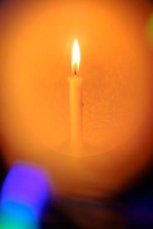 Still life golden candle light with reflection on CD disc and golden blurred bokeh background....