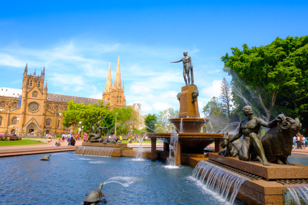 SYDNEY, AUSTRALIA - November 26, 2017: Sydney Australia landmark hyde park day time archibald fountain water sunny reflection trees and cathedral at St Andrew's Cathedral from Hyde Park, Sydney.のeditorial素材