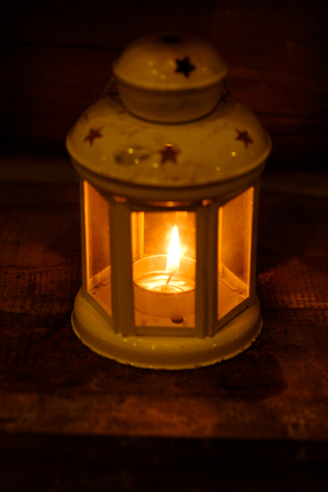 Retro style lantern with a candle at nightà¹の写真素材