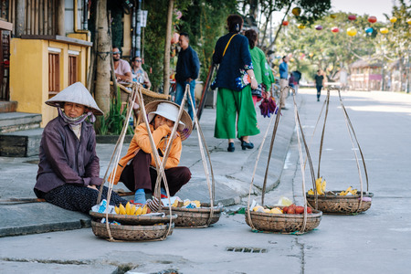 Hoi An street food , Vietnam - 10 May 2018: A Vietnamese trading her vegetables in local market among the Hoi An street food.のeditorial素材