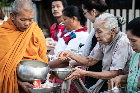 Kanchanaburi,Thailand- May 8,2018: Traditional buddhist alms giving ceremony in the morning at ...