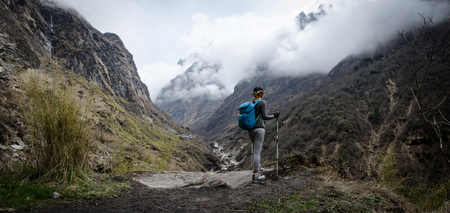 Travel concept , Trekker on the way at mountain peak cliff, Hiker with backpack standing on top of a mountain.の写真素材
