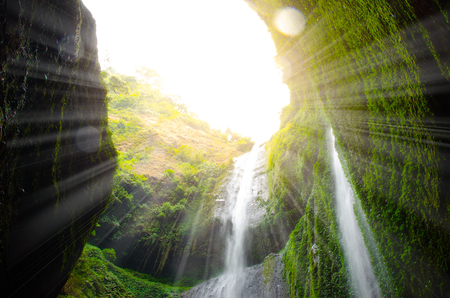 Madakaripura Waterfall with sunlight effect is the tallest waterfall in deep forest in Java and the second tallest waterfall in Indonesia.の写真素材