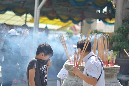 The boy with incense smokeの写真素材