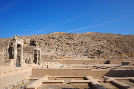 Ruins of Apadana and Tachara Palace behind stairway with bas relief carvings in Persepolis  against cloudy blue sky in Shiraz city of Iran.の写真素材