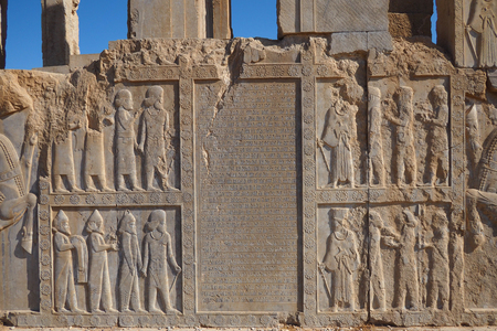 Ruins of Apadana and Tachara Palace behind stairway with bas relief carvings in Persepolis against cloudy blue sky in Shiraz city of Iran.の写真素材