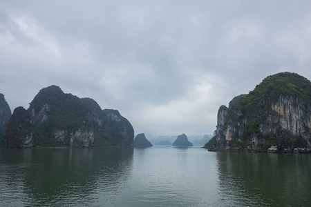 Vietnam Island Cat ba Halong. Group of rocky islands covered with vegetation in azure sea. Sand beach. Blue cloudless skyの写真素材