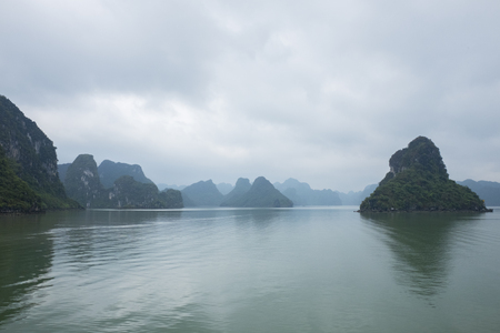 Vietnam Island Cat ba Halong. Group of rocky islands covered with vegetation in azure sea. Sand beach. Blue cloudless skyの写真素材