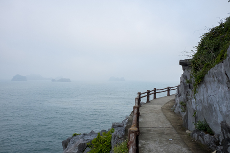 Vietnam, halong, catba. Rocky island in azure sea. Blue cloudless sky. Smaller islands in backgroundの写真素材