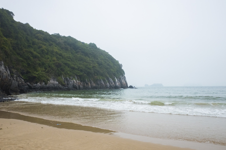 Vietnam, halong, catba. Rocky island in azure sea. Blue cloudless sky. Smaller islands in backgroundの写真素材