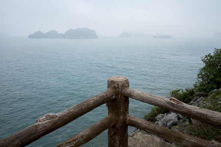 Vietnam, halong, catba. Rocky island in azure sea. Blue cloudless sky. Smaller islands in backgroundの写真素材