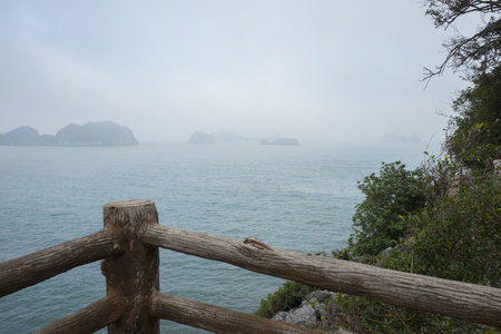 Vietnam, halong, catba. Rocky island in azure sea. Blue cloudless sky. Smaller islands in backgroundの写真素材