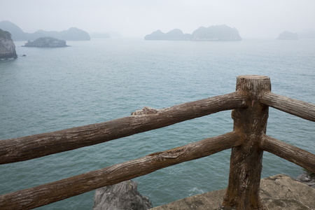 Vietnam, halong, catba. Rocky island in azure sea. Blue cloudless sky. Smaller islands in backgroundの写真素材