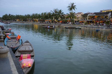 HOI AN, VIETNAM. A view of the Hoi An Thu Bon River. Buildings, boats, reflections and locals can be seen.のeditorial素材