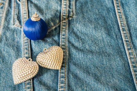 Silver heart decorated on jeans for background.の写真素材
