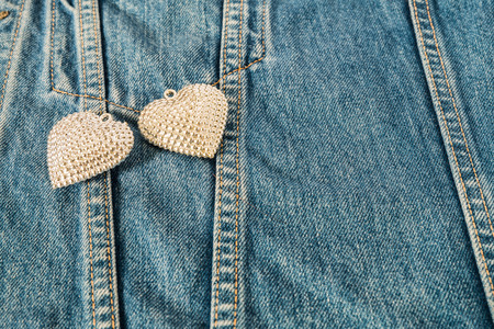 Silver heart decorated on jeans for background.の写真素材