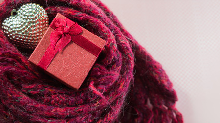 Valentines Day background with Close up Gift box, Silver heart on scarves. Love concept.の写真素材