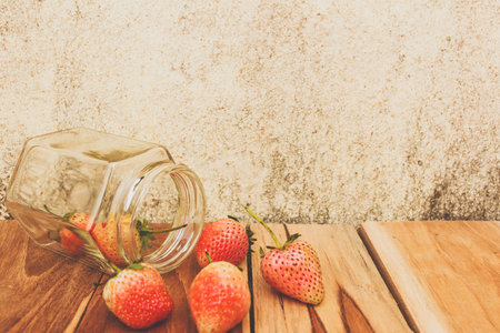 Strawberry jar on a wooden, process color with Vintage Tones. Focusing on jar.の写真素材