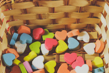 Colorful small hearts in basket, Process color with vintage tone, soft focus.の写真素材