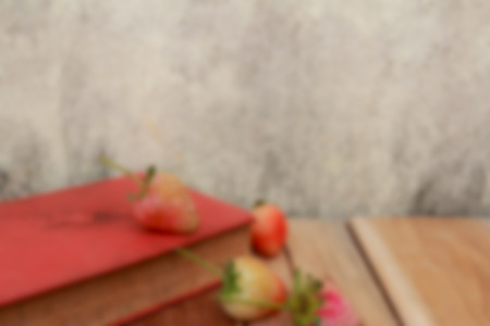 Blur book, Strawberry on wooden and background of old wall.の写真素材