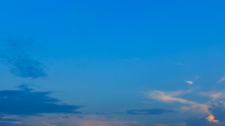 blue sky with tiny clouds before sunsetの写真素材