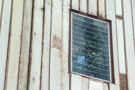 glass window on the wooden wall.