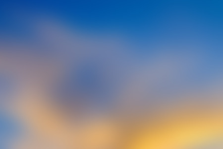 abstract blurred background of blue sky with golden clouds, sunrise time.の写真素材
