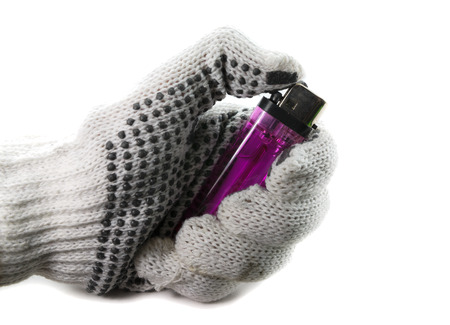 gloved hand holding a lighter on a white background, safety first conceptの写真素材