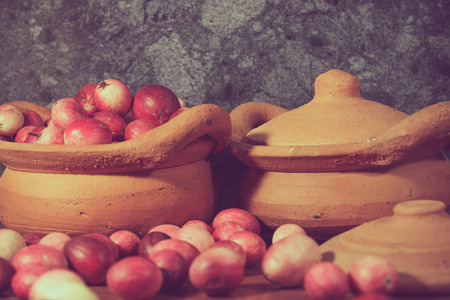 close up: carissa carandas in earthenware on a wooden, process color.の写真素材