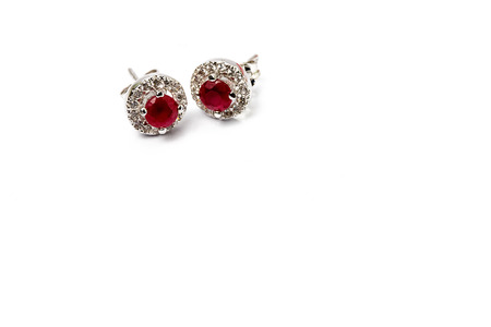ruby earrings on white background.の写真素材